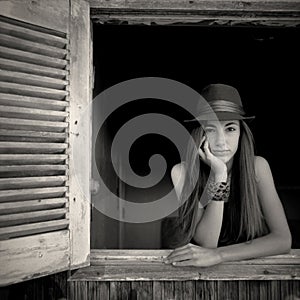 Girl posing in an open window