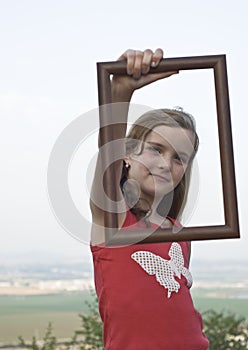Girl posing with picture frame