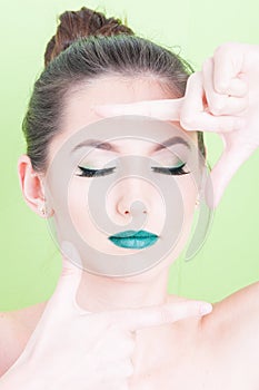 Girl posing with professional trendy make-up as photo gesture