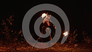 Girl in post-apocalyptic costume spins ignited poi