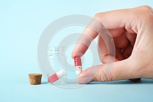 Girl pours the last pills into her palm on a light background close-up. vitamins. pharmaceuticals. chemical industry.