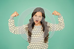 Girl power. Little girl flex arms blue background. Small girl with long hair show strength. Fit and fitness. Beauty and