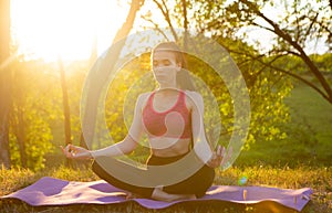 The girl practices yoga in the fresh air, filled with energy for the day.