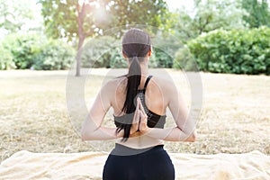 Girl practices yoga and meditates , nature background with copy space