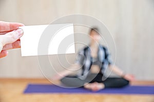 The girl practices yoga and sits in the lotus position with mudras in her hands