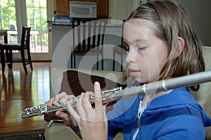 Girl practicing flute at home