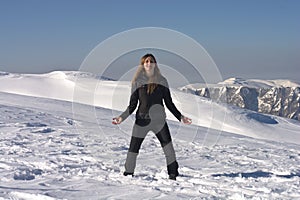 The girl Practicing Yoga at high altitude among the snows