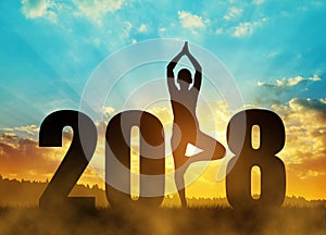 Girl practicing yoga in the New Year 2018.