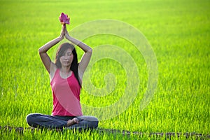 Girl practicing yoga in paddy field