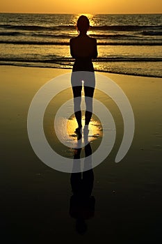 Girl practicing yoga during the sunset