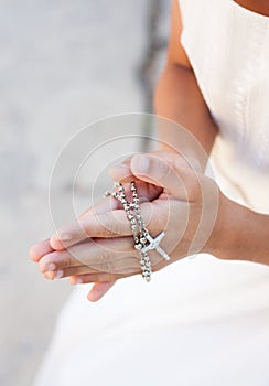 Girl praying with crucifix