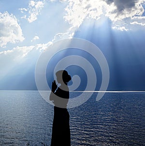 Girl praying to the God photo