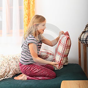 Girl prepairing bed for sleeping