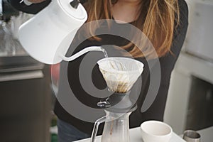 The girl prepared water in the machine for make coffee drip process