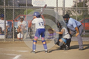 Girl preparing at bat with umpire, Girls Softball game, Brentwood, CA