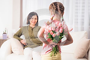 Girl is preparing surprise for mother