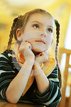 Girl-preschooler sitting at table