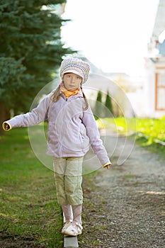 Girl-preschooler walking on curb