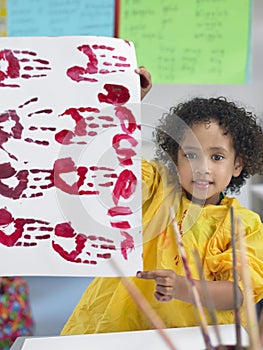 Girl Presenting His Finger Painting In Class