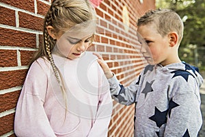 Girl problem at school, sitting and consoling child each other