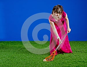 Girl in prom dress playing with lacrosse stick