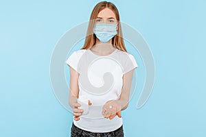 Girl in a protective medical mask on her face, holding a jar of pills. Concept of a virus or coronavirus