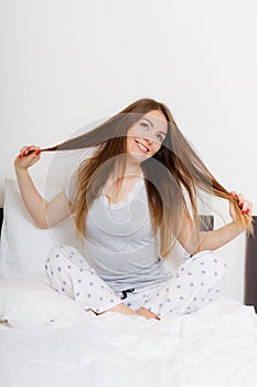 Girl pulling hair in bed.