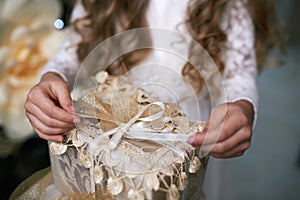 Girl pulls the ribbon opening gift