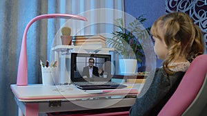 Girl pupil doing school homework with man teacher, using laptop computer at home, distance education