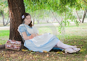 Girl pupil fell sleep under a tree with a book.