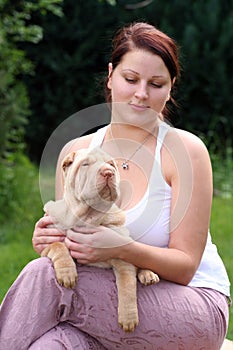 Girl with a puppy sharpei