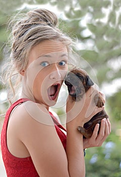 Girl and puppy yawning