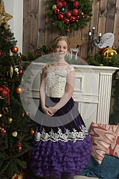 Girl in purple dress at christmas