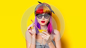 Girl with purple hair holding lemonade cocktail