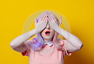 Girl with purple hair and pink dress on yellow background