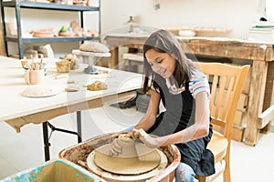 Girl Pursuing Hobby Of Pottery In Class