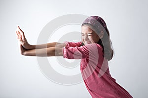 Girl pushing imaginary wall