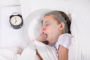 The girl put the watch on the signal and went to bed