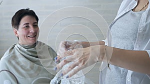 The girl puts on cellophane gloves. Hair dye