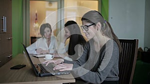 Girl puts glasses on laptop keyboard