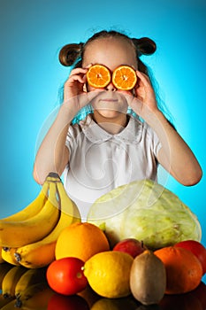 Girl puts oranges on her eyes