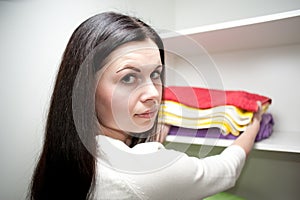 The girl puts towels