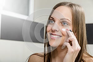 Girl putting anti-aging cream