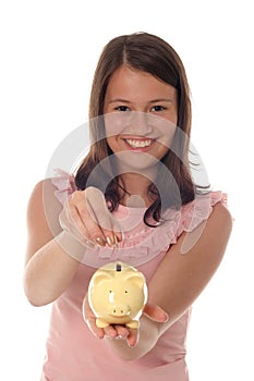 Girl putting coin in piggy bank