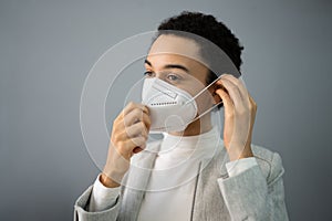 Girl Putting FFP2 Face Mask Respirator photo