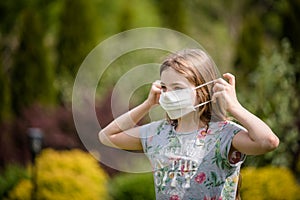 Girl putting a mask on her face