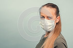 A girl is putting on a protective mask. Respiratory protection from coronavirus. Personal protective equipment for a