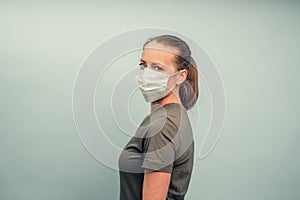 A girl is putting on a protective mask. Respiratory protection from coronavirus. Personal protective equipment for a