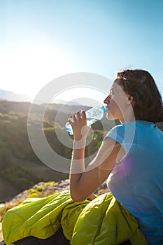 The girl quenches his thirst.