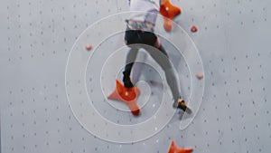 Girl quickly climbs up the training wall